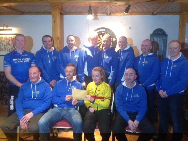 Shenna receives a donation from the members of West Down Wheelers